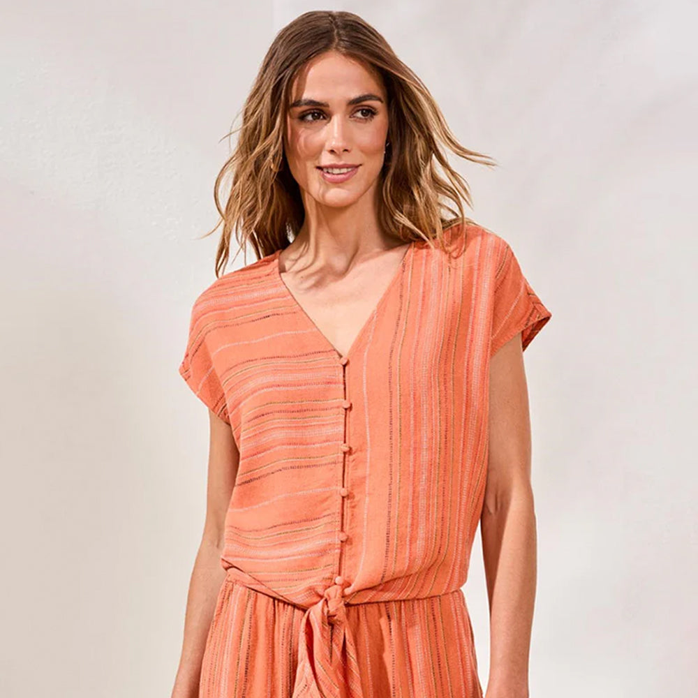 Woman wearing an orange dress against a plain background