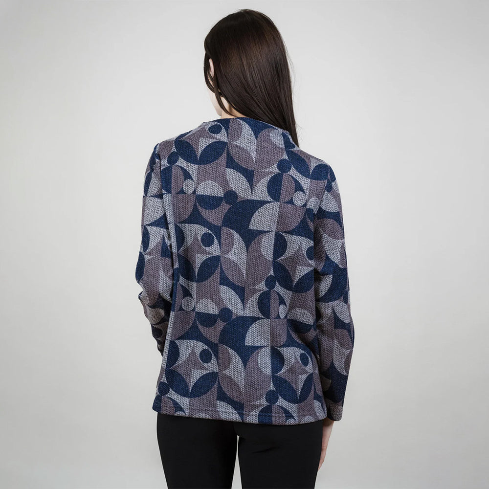 Person wearing a patterned jacket on a plain background