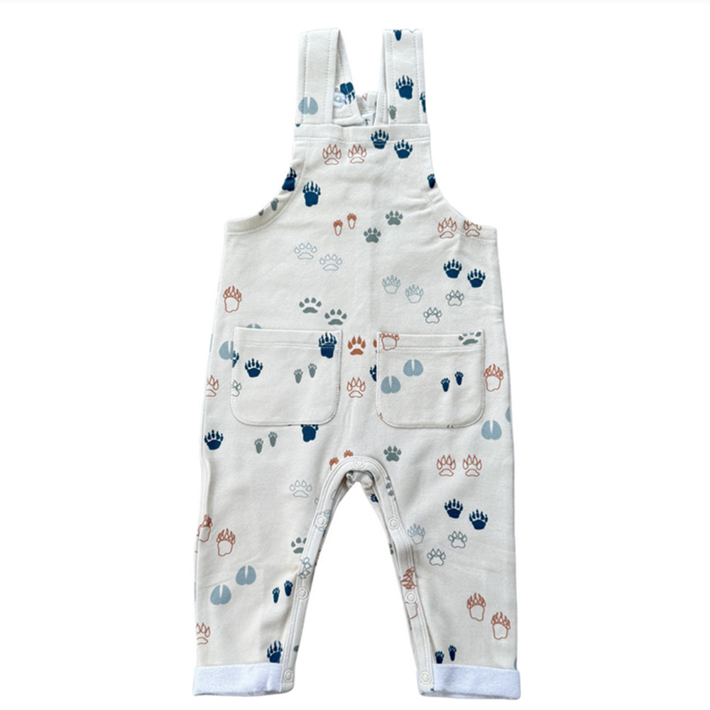 Baby overalls with paw print pattern on a white background
