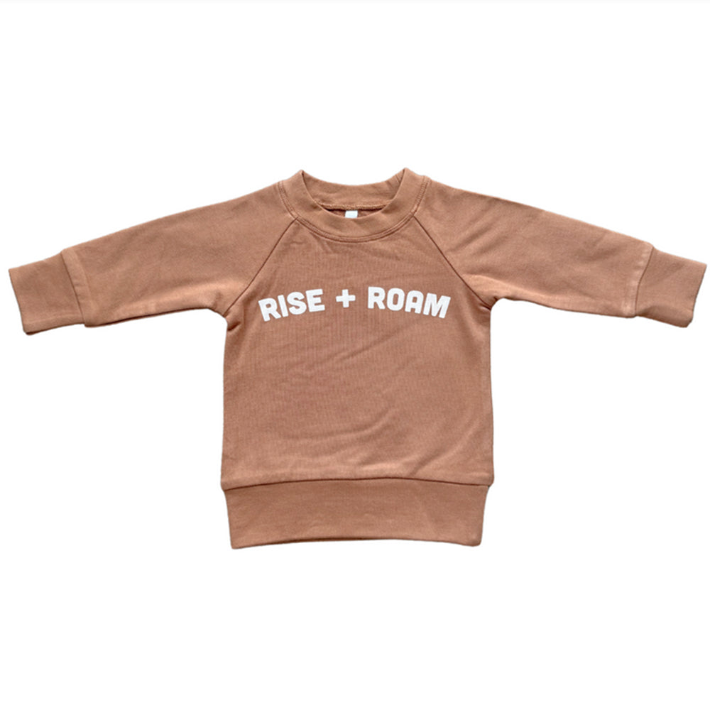 Brown sweatshirt with 'RISE + ROAM' text on a white background
