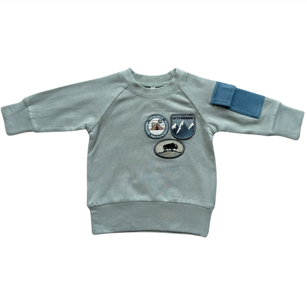 Light gray sweatshirt with patches on a white background