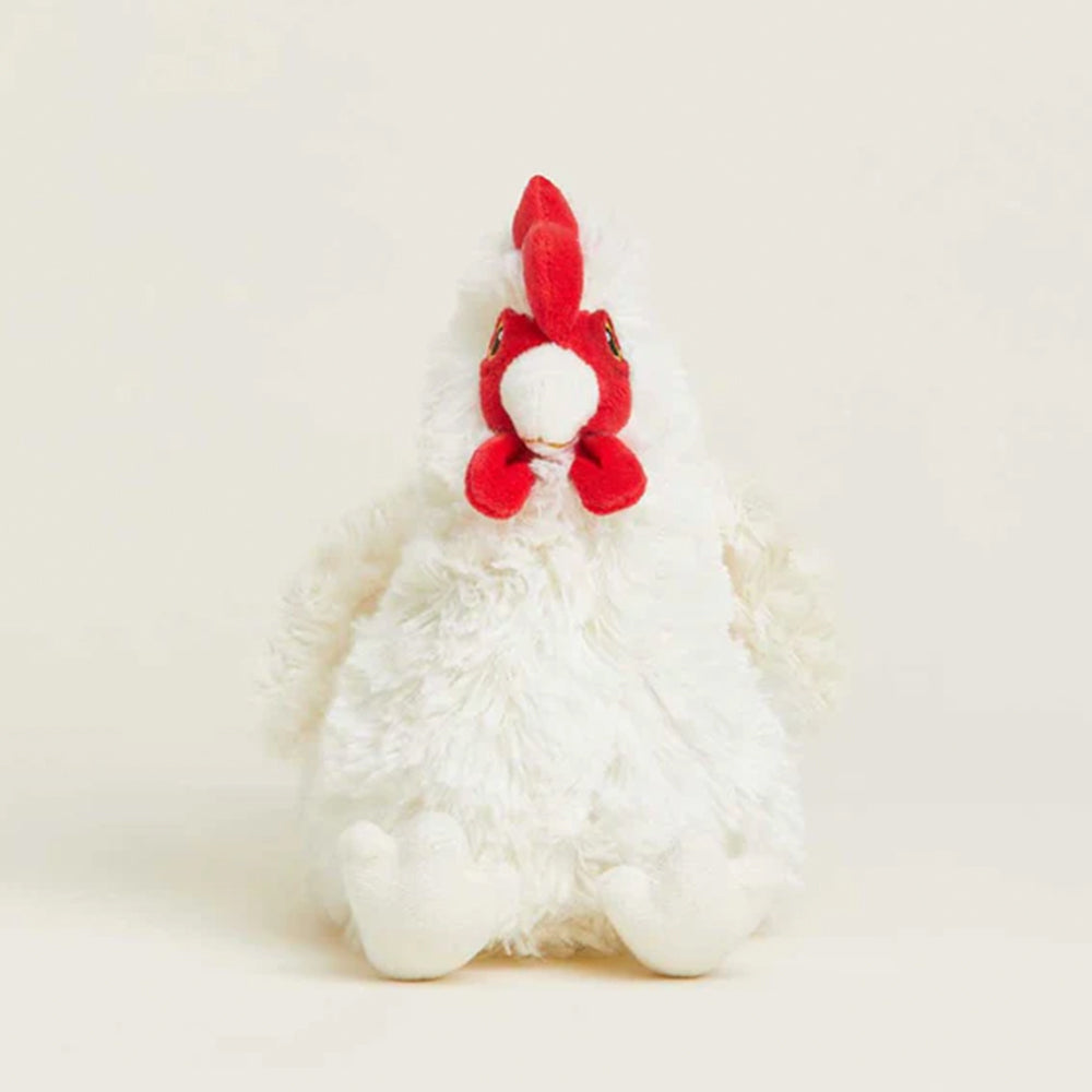 White plush toy with red accents on a light beige background