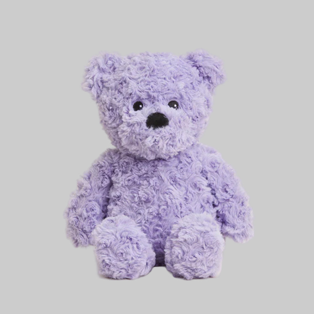Purple teddy bear on a light gray background