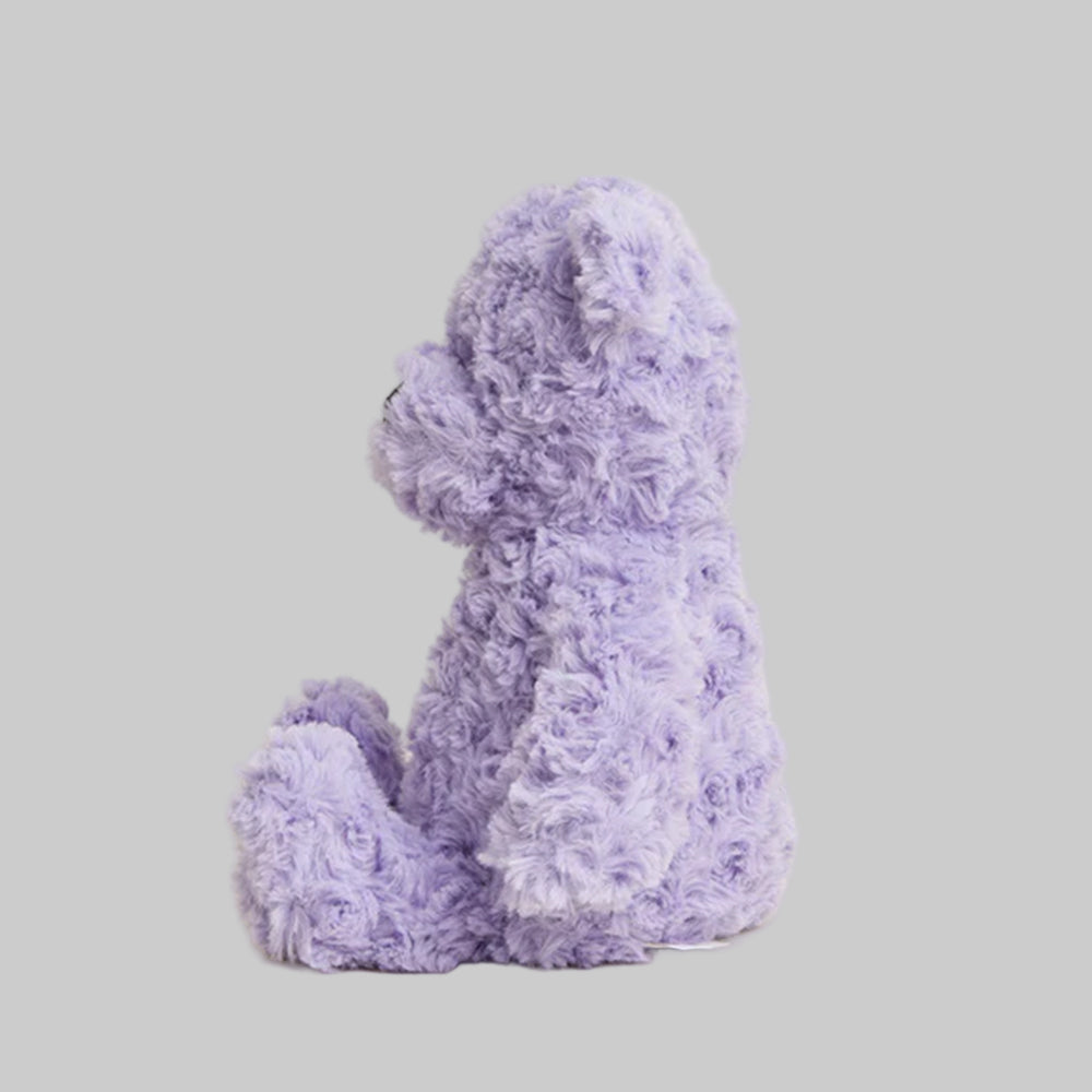 Purple teddy bear on a light gray background