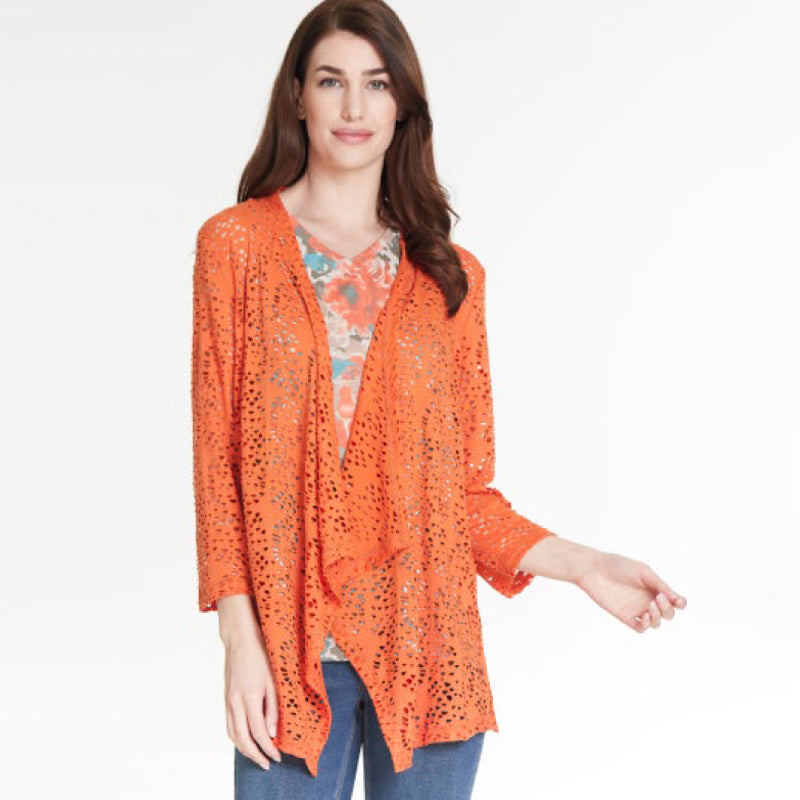 Women with brown hair wearing a multiples coral lace cardigan with a paisley top and blue jeans.  
