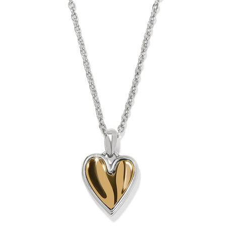 Heart-shaped pendant with gold interior and silver exterior on a chain against a white background