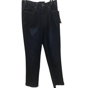 Dark wash blue jeans hanging on a hanger against a white paneled wall with patterned lace curtains on both sides.