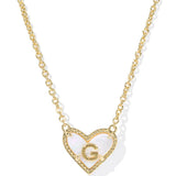 Gold necklace with a heart-shaped pendant featuring the letter 'G' on a white background