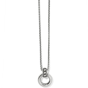 Silver necklace with a circular pendant on a white background