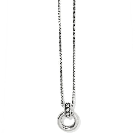 Silver necklace with a circular pendant on a white background