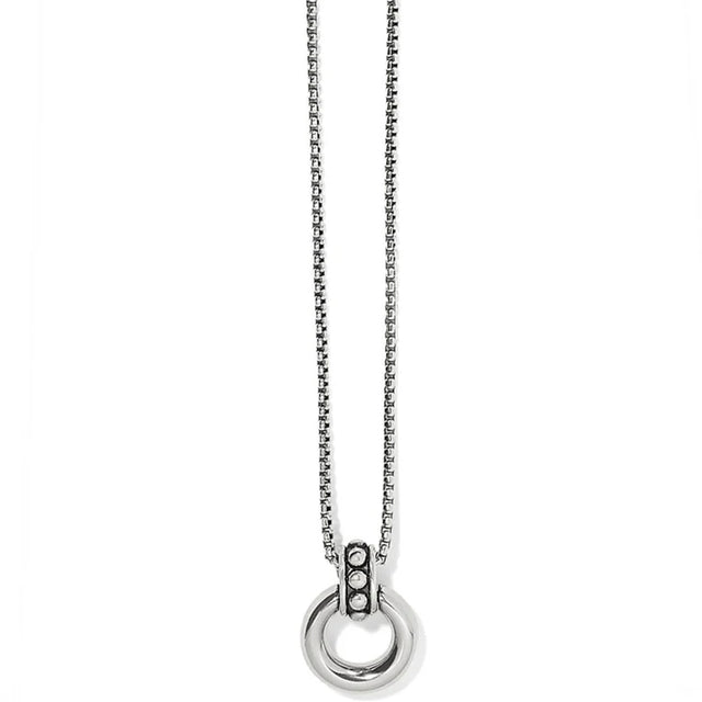 Silver necklace with a circular pendant on a white background
