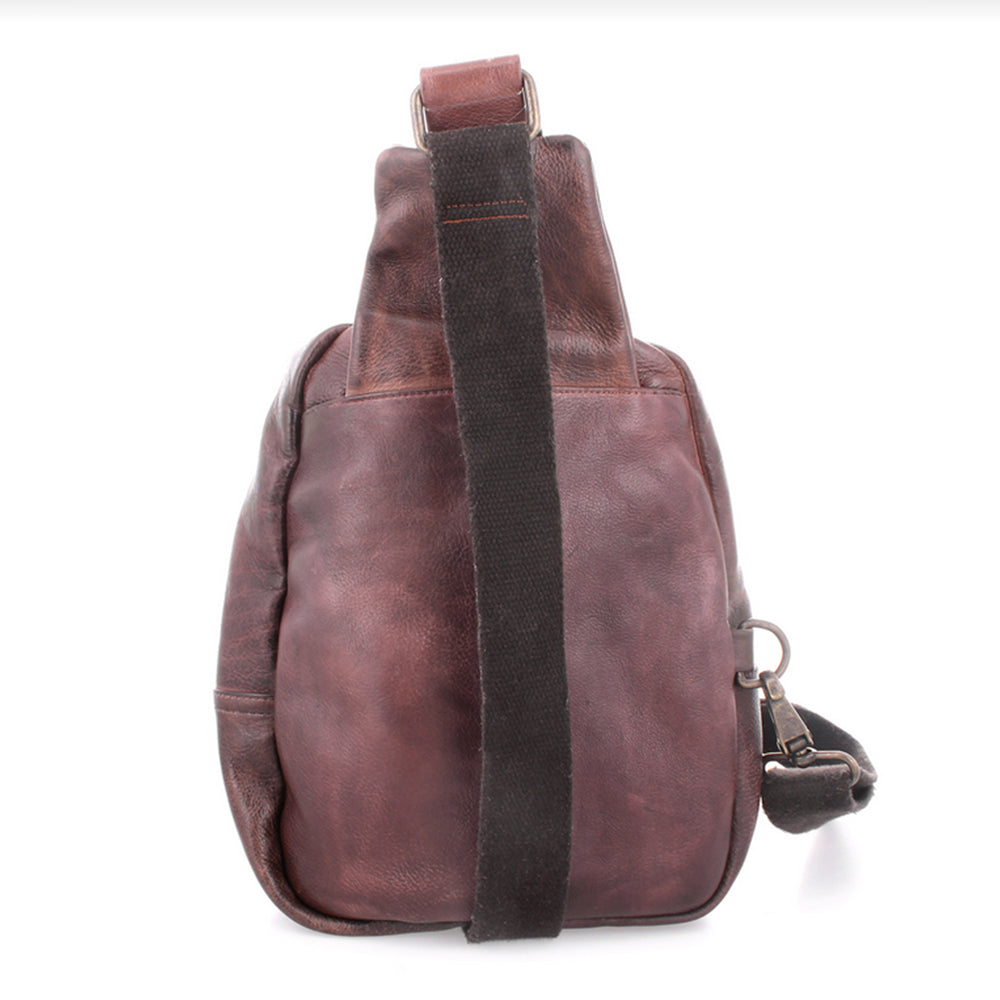 Brown leather backpack with a strap on a white background