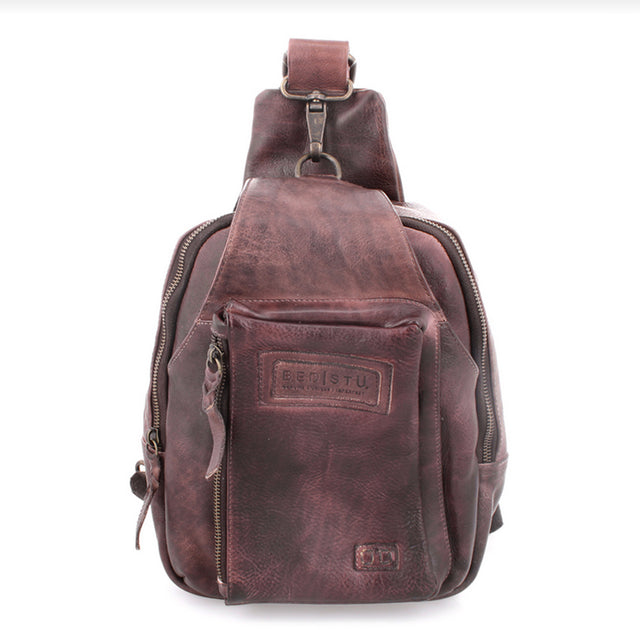 Brown leather sling bag with visible brand logo on a white background