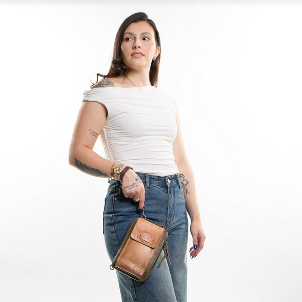 Woman holding a brown leather bag against a white background