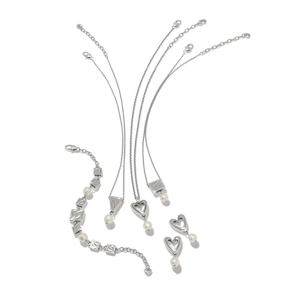 Silver jewelry set with necklaces and heart-shaped pendants on a white background