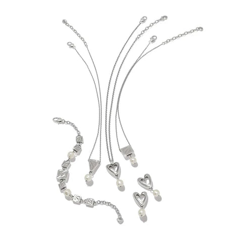 Silver jewelry set with necklaces and heart-shaped pendants on a white background