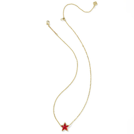 Gold necklace with a red star pendant on a white background