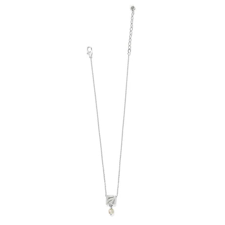 Silver necklace with a small pendant on a white background