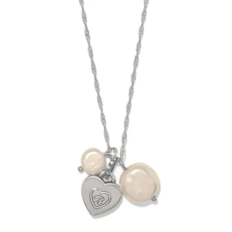 Necklace with heart-shaped charm and pearl beads on a white background