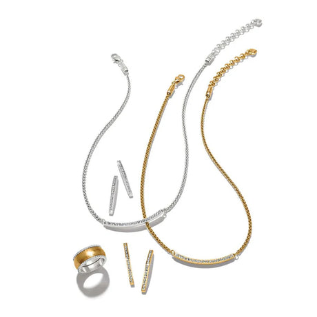 Gold and silver jewelry set including necklaces and a ring on a white background