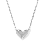 Silver heart-shaped pendant on a chain against a white background