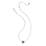 Silver necklace with a red pendant on a white background