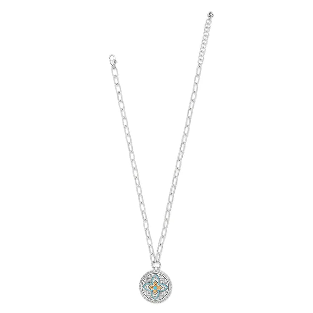 Silver necklace with a round pendant on a white background