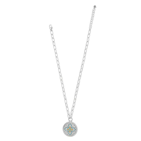 Silver necklace with a round pendant on a white background