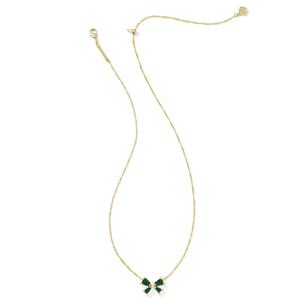 Gold necklace with a green bow pendant on a white background
