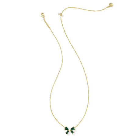 Gold necklace with a green bow pendant on a white background