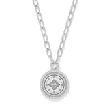 Silver necklace with a round pendant on a white background