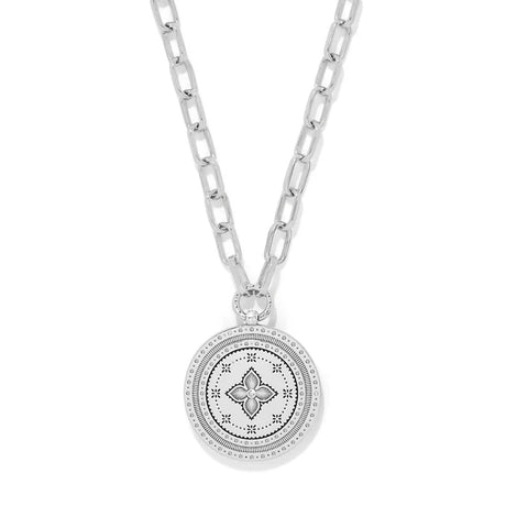 Silver necklace with a round pendant on a white background