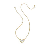 Gold necklace with a heart-shaped pendant on a white background