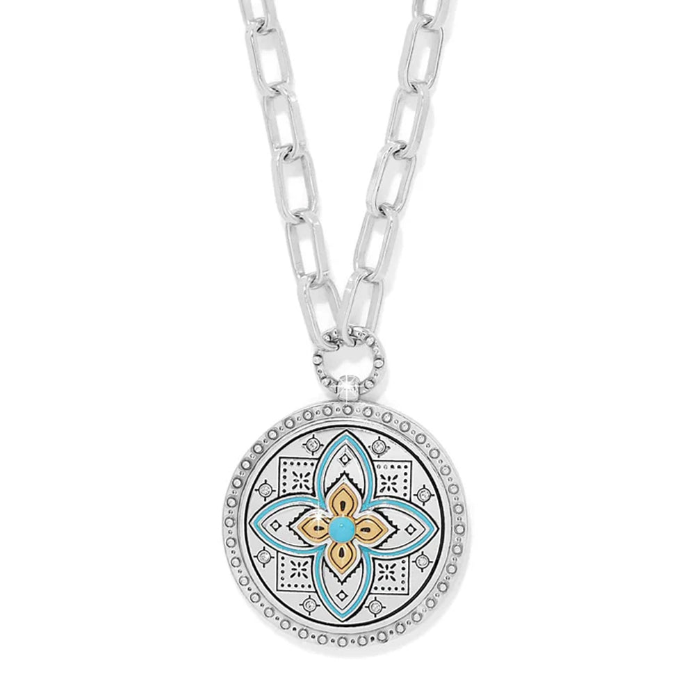 Necklace with a decorative pendant featuring a floral design on a white background