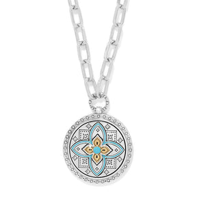 Necklace with a decorative pendant featuring a floral design on a white background