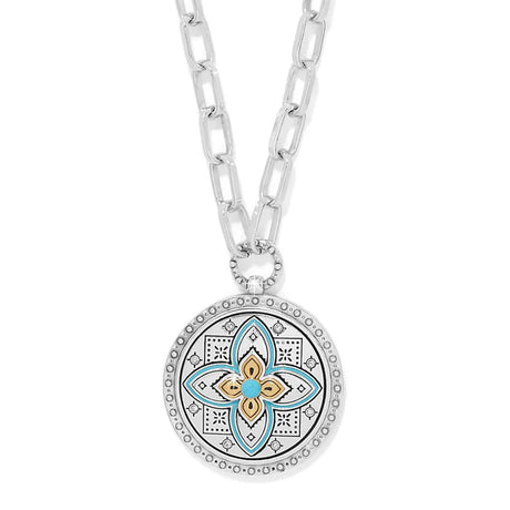 Necklace with a decorative pendant featuring a floral design on a white background