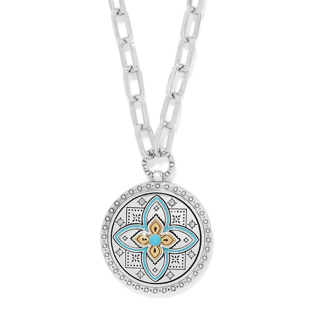 Necklace with a decorative pendant featuring a floral design on a white background