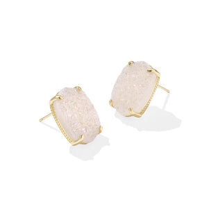 Pair of earrings with beige stone and gold frame on a white background