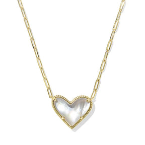 Heart-shaped pendant necklace with gold chain on a white background