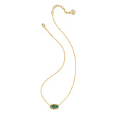 Gold necklace with a green gemstone pendant on a white background