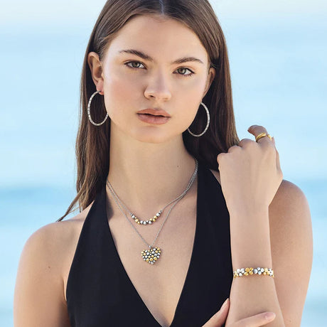 Woman wearing jewelry with a clear blue sky background