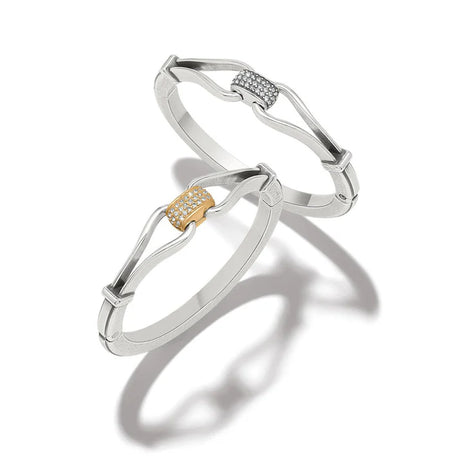 Two silver bracelets with gold accents on a white background