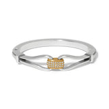 Silver ring with a gold heart-shaped center on a white background