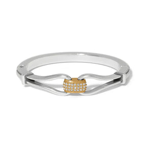 Silver ring with a gold heart-shaped center on a white background