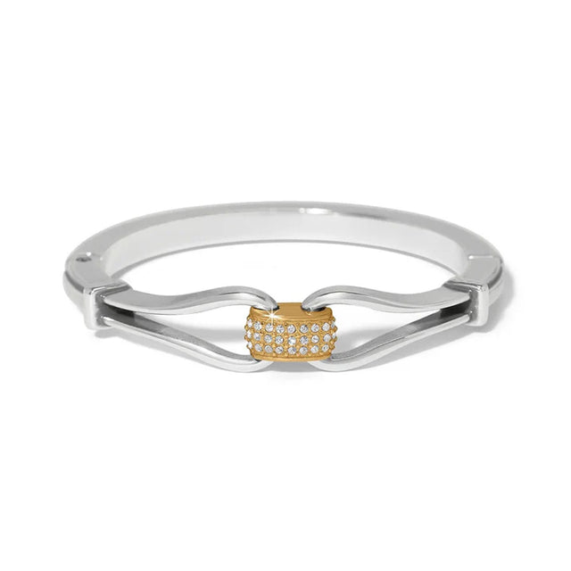 Silver ring with a gold heart-shaped center on a white background
