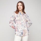 Woman wearing a floral blouse against a plain background