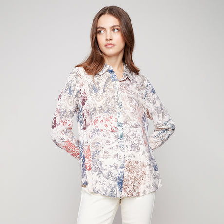 Woman wearing a floral blouse against a plain background