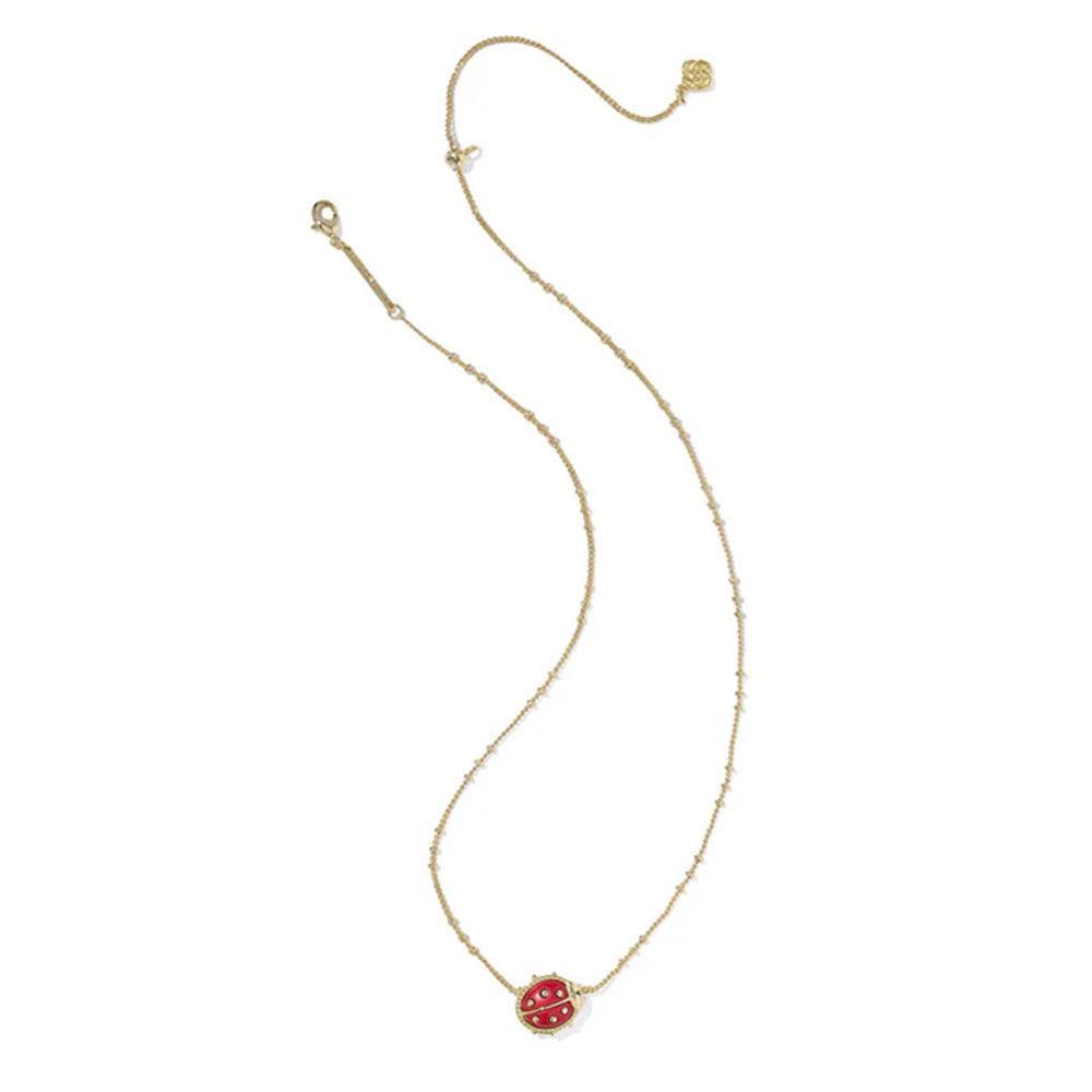 Gold necklace with a red pendant on a white background