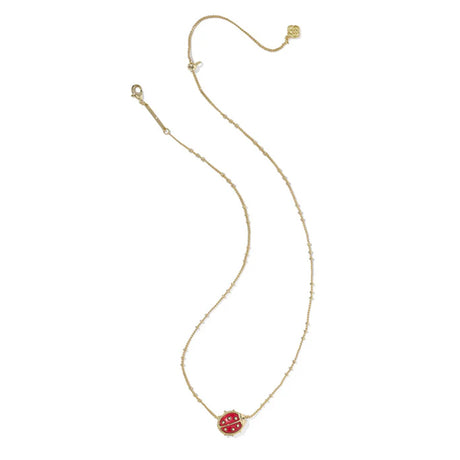 Gold necklace with a red pendant on a white background