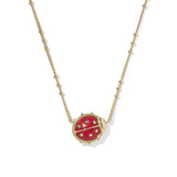 Red ladybug pendant necklace on a gold chain against a white background